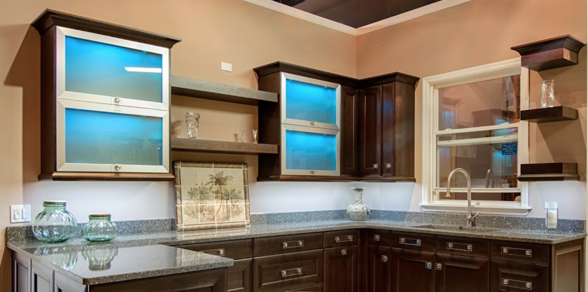 Dark wood kitchen cabinets with illuminated glass doors