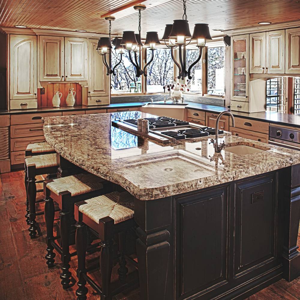 Traditional kitchen with a large island, wood cabinets and dark pendant lights